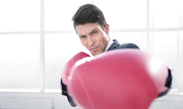 confident young businessman in Boxing gloves. concept of competitiveness