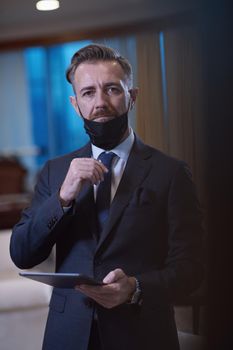 corporate business man wearing protective medical face mask at luxury office