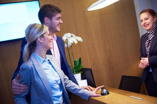 Couple on a business trip doing check-in at the hotel