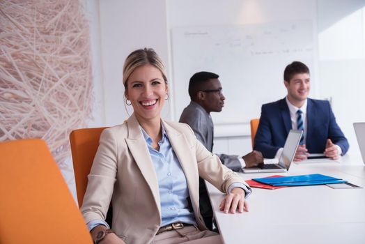 business woman with her staff, people group in background at modern bright office indoors