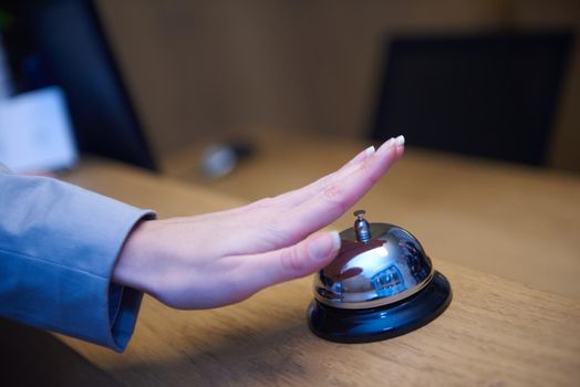 business woman at the reception of a hotel checking in