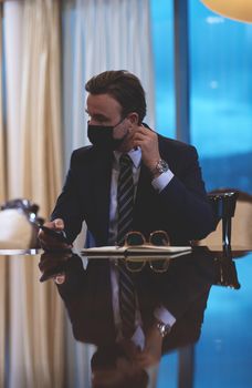 corporate business man wearing protective medical face mask at luxury office