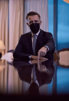 corporate business man wearing protective medical face mask at luxury office