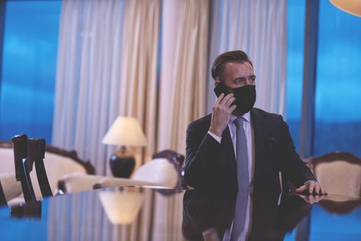 corporate business man wearing face mask and  using smart phone at luxury office