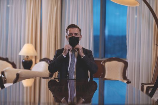 corporate business man wearing protective medical face mask at luxury office