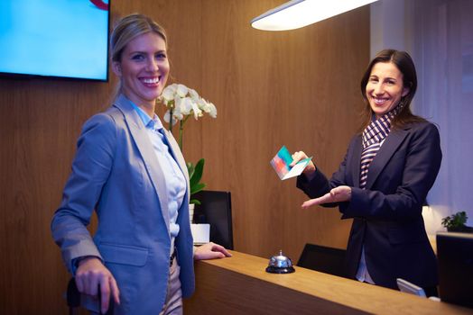 Couple on a business trip doing check-in at the hotel