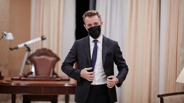 corporate business man wearing protective medical face mask at luxury office