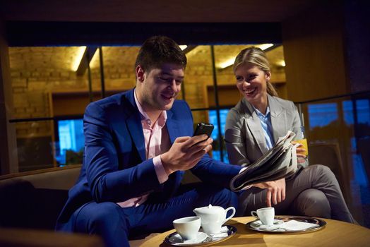 young business people couple relaxing after work in bar restaurant and take drink