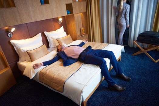 relaxed and happy young couple in modern hotel room