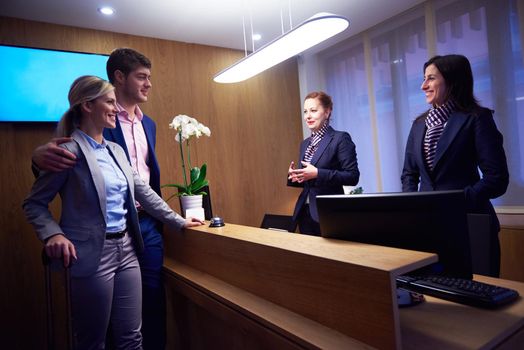 Couple on a business trip doing check-in at the hotel