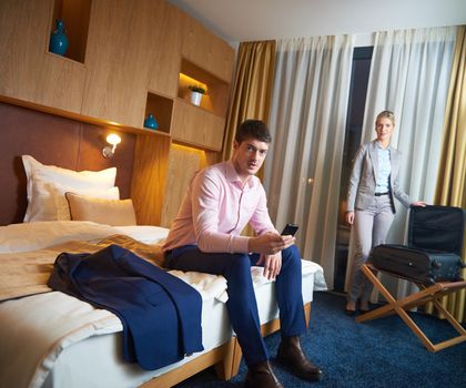 relaxed and happy young couple in modern hotel room