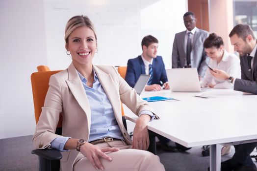 business woman with her staff, people group in background at modern bright office indoors