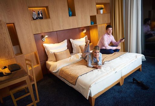 relaxed and happy young couple in modern hotel room