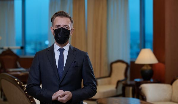 corporate business man wearing protective medical face mask at luxury office