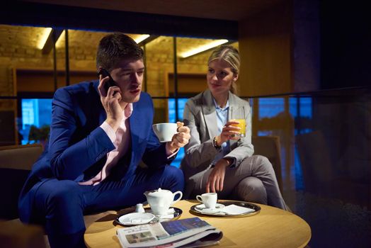 young business people couple relaxing after work in bar restaurant and take drink