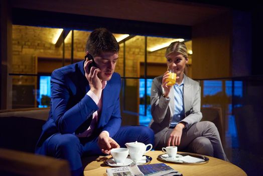 young business people couple relaxing after work in bar restaurant and take drink