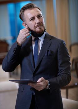 corporate business man wearing protective medical face mask at luxury office