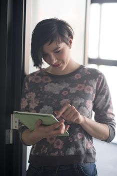 yonug businesswoman in casual hipster clothes working on tablet computer at modern startup business office interior