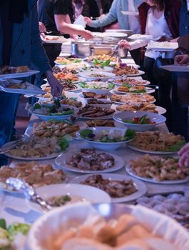 people group catering buffet food indoor in school  restaurant with meat colorful fruits and vegetables