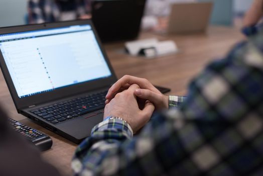 software developer writing programming code on laptop computer