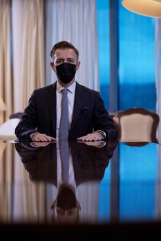 corporate business man wearing protective medical face mask at luxury office