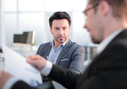 close up. two employees discussing business documents.office weekdays