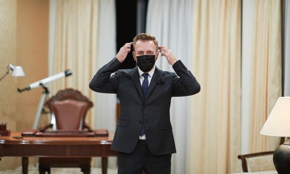 corporate business man wearing protective medical face mask at luxury office