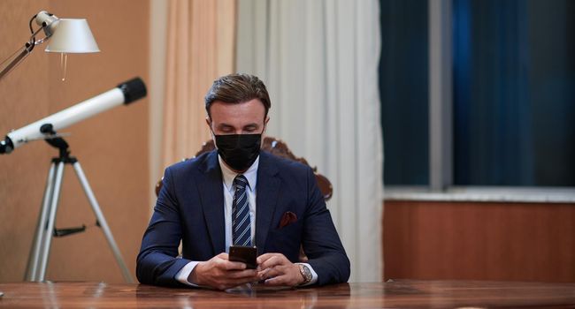 corporate business man wearing protective medical face mask at luxury office