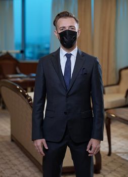 corporate business man wearing protective medical face mask at luxury office