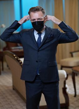 corporate business man wearing protective medical face mask at luxury office