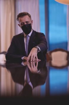 corporate business man wearing protective medical face mask at luxury office