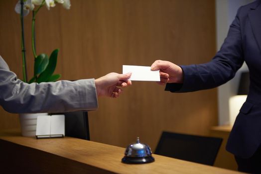 Couple on a business trip doing check-in at the hotel