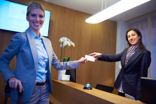 Couple on a business trip doing check-in at the hotel