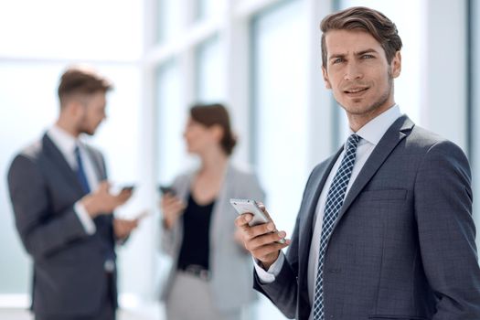 serious businessman reading SMS on his smartphone.photo with space for text