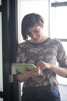 yonug businesswoman in casual hipster clothes working on tablet computer at modern startup business office interior