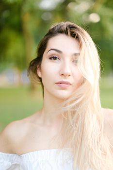 Portrait of young caucasian girl, green background. Concept of beauty and everyday makeup.