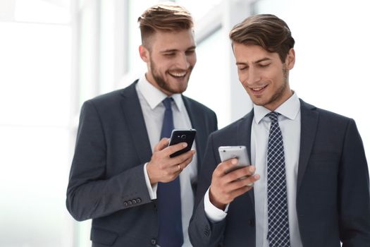 two employees using their smartphones on a work break.people and technology