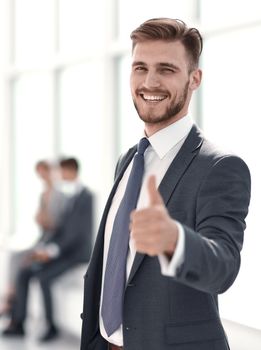 smiling businessman showing thumb up.photo with copy space