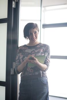 yonug businesswoman in casual hipster clothes working on tablet computer at modern startup business office interior