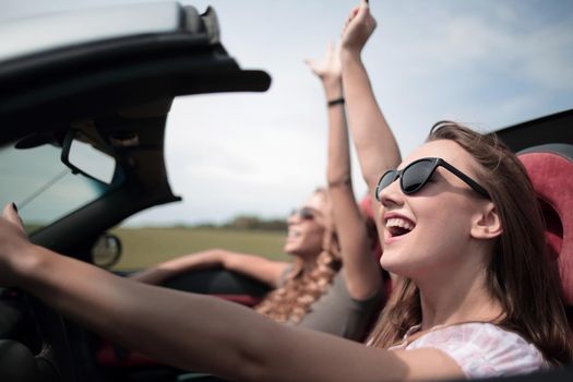 close up.two young women traveling in a car .The freedom of the open road.