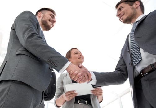 bottom view.handshake business partners standing in the office.concept of cooperation