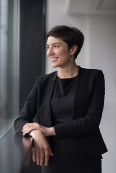 Portrait Of Successful Businesswoman by the window Entrepreneur At Busy startup Office