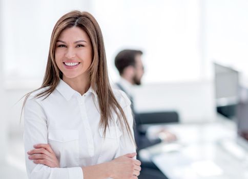 smiling business woman on the background of the workplace. photo with copy space