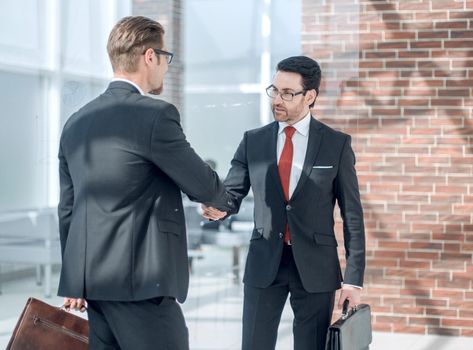 business hands shaking hands in the office hall . the concept of cooperation