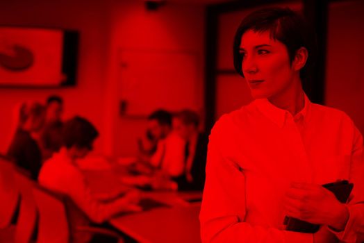 young hispanic businesswoman portrait with  tablet computer at modern startup business office interior, people group on team meeting blured in background