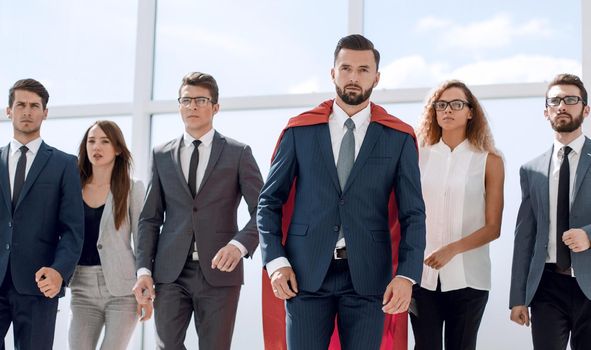 businessman in a red superhero cloak and his business team.photo with copy space