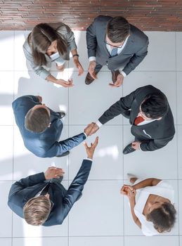 top view.business partners shaking hands.business concept