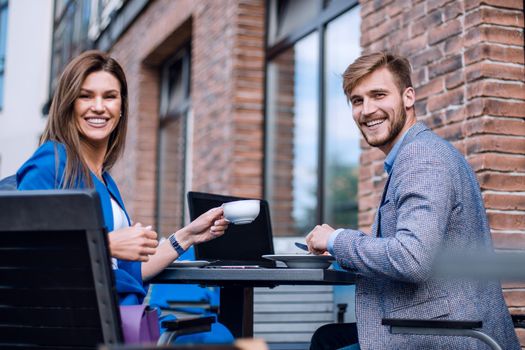 business couple at a meeting in a street cafe.lunch break