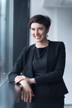 Portrait Of Successful Businesswoman by the window Entrepreneur At Busy startup Office