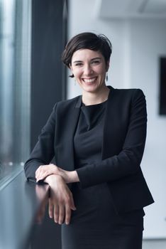 Portrait Of Successful Businesswoman by the window Entrepreneur At Busy startup Office